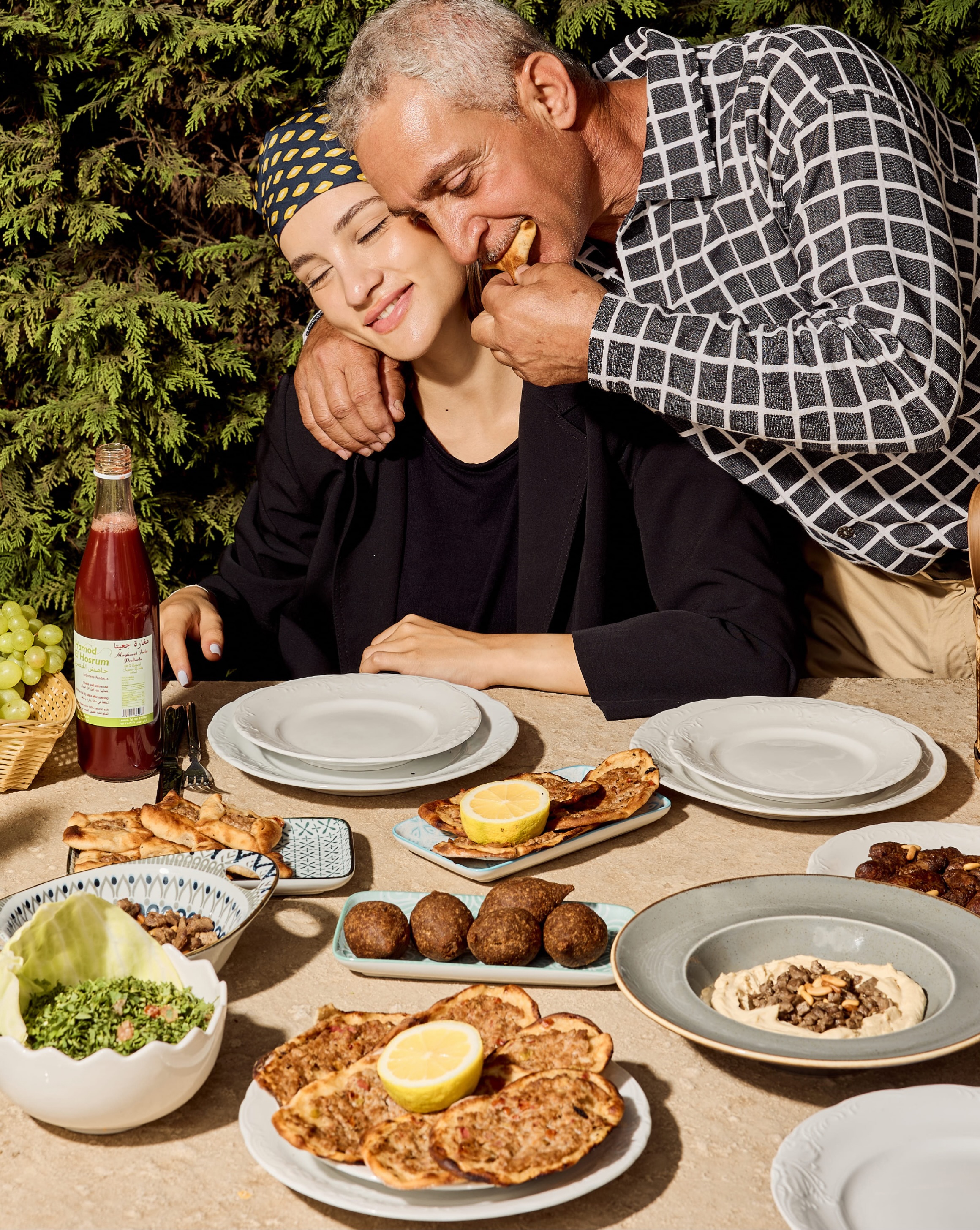 Lebanese family sharing mezze and Hamod El Hosrum on terrace